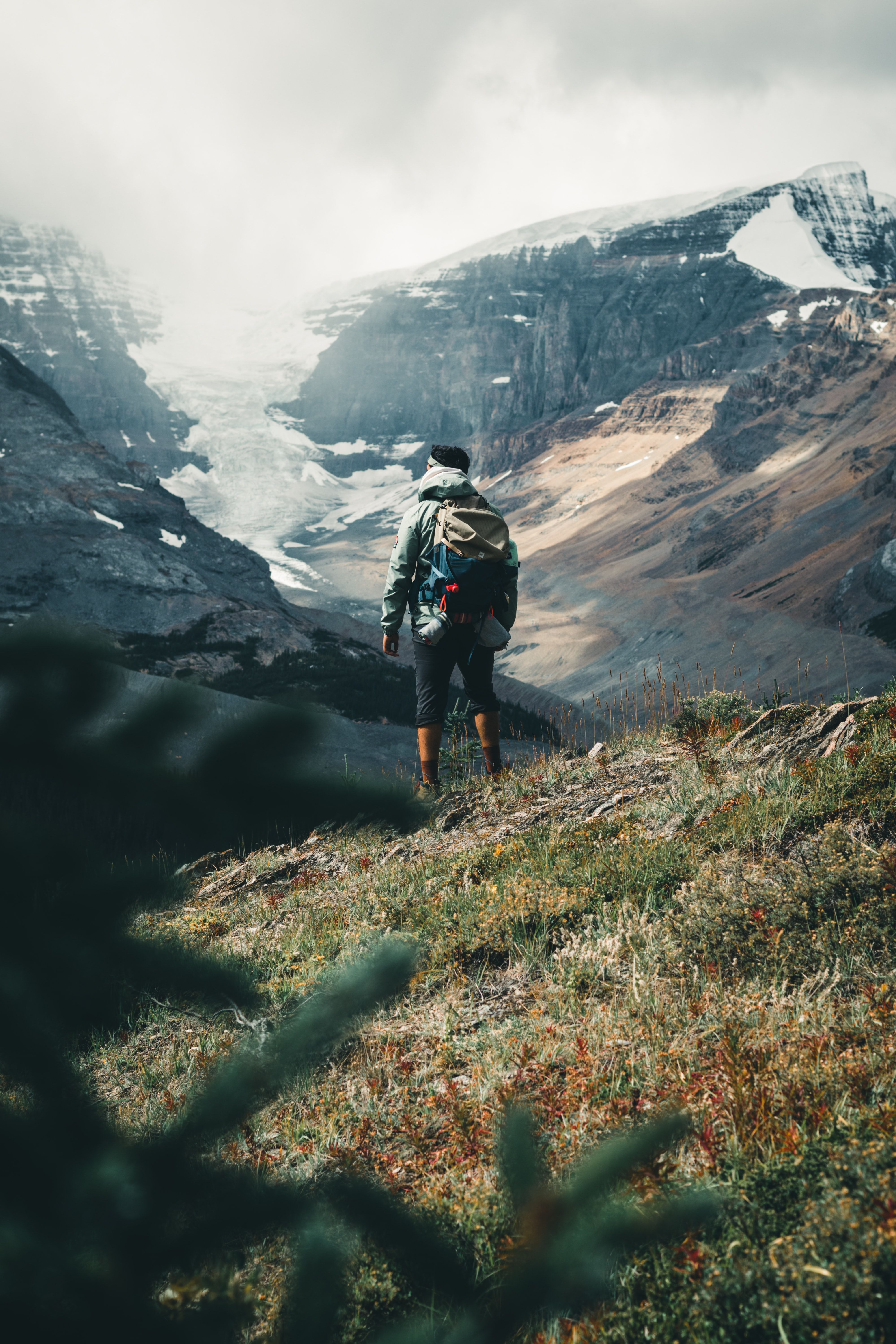 A hiker looking over a dramatic mountain landscape