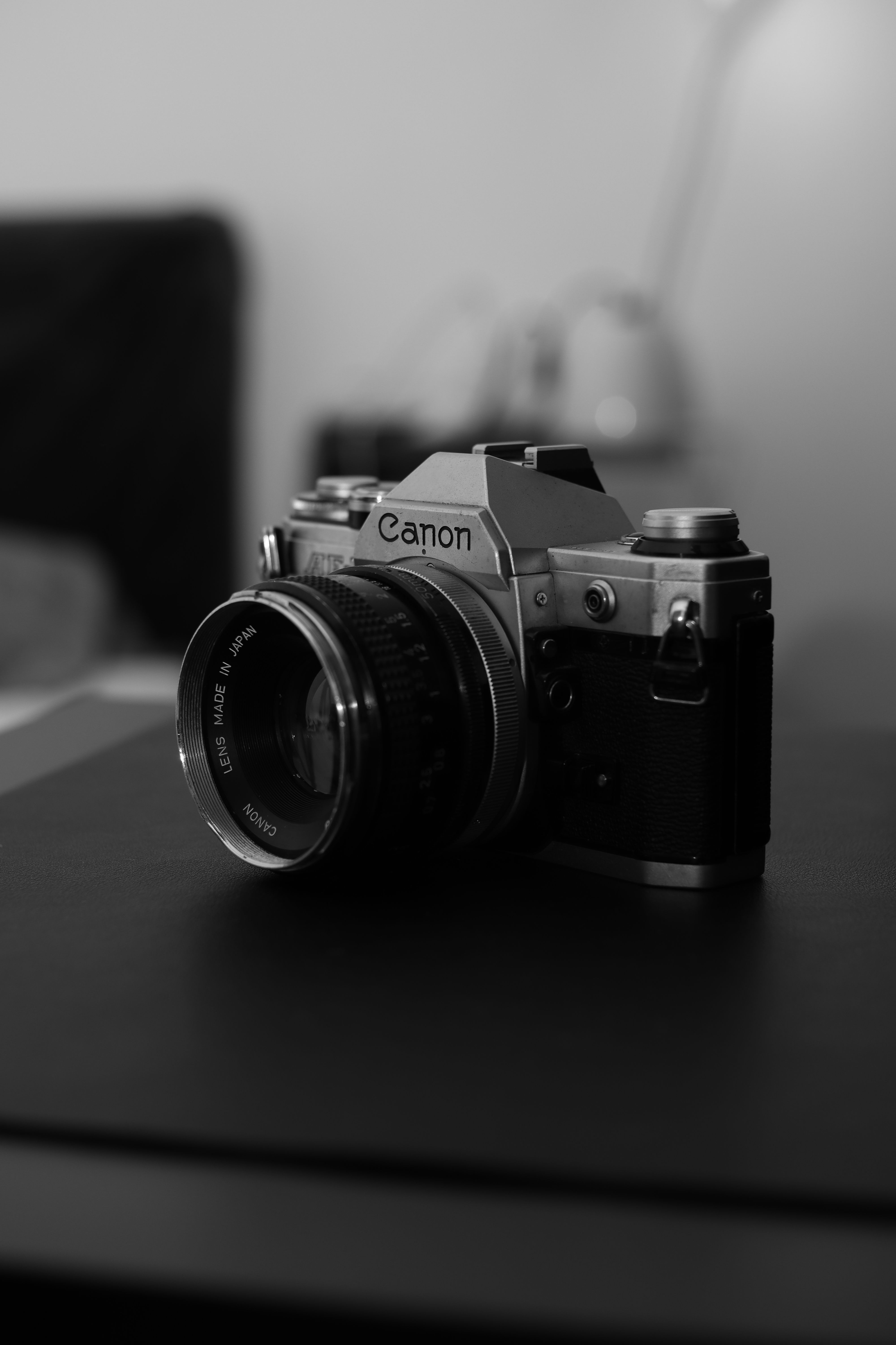 A black and white vintage camera resting on a table