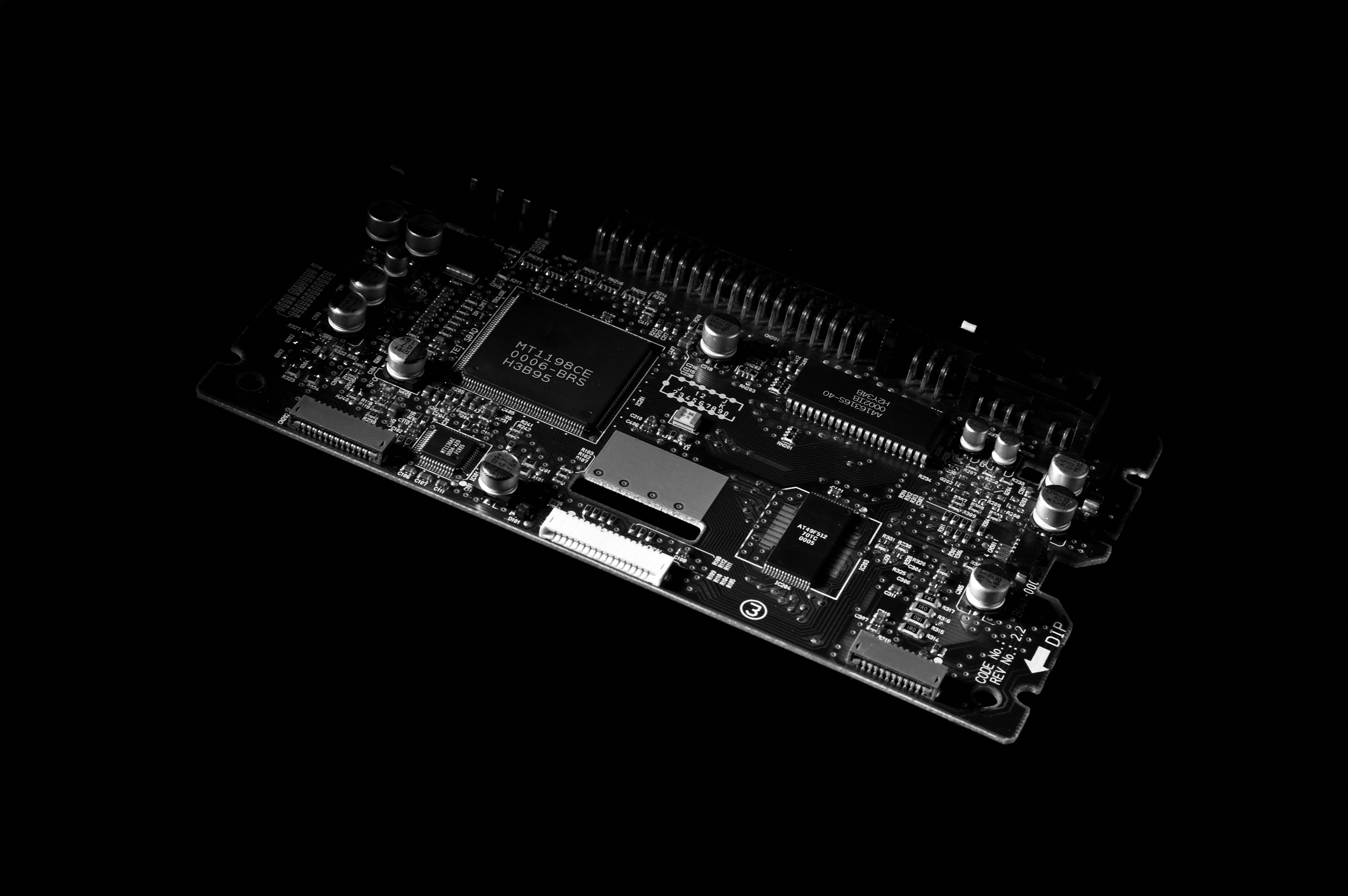 A black and white circuit board against a dark background